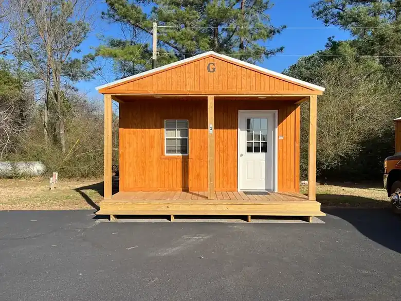 A rustic cabin with a covered front porch