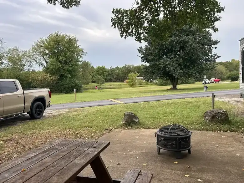 A fire pit and picnic table looking out over the grounds